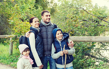 Image showing happy family with backpacks hiking