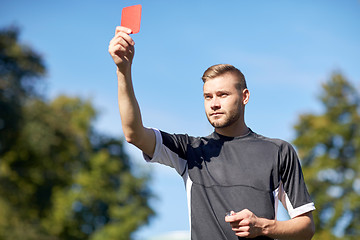 Image showing referee on football field showing yellow card