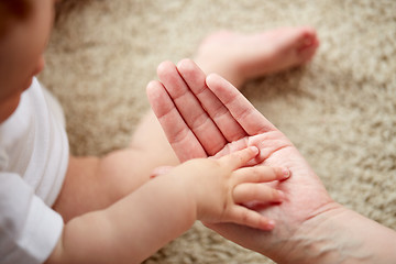 Image showing close up of little baby and mother hands