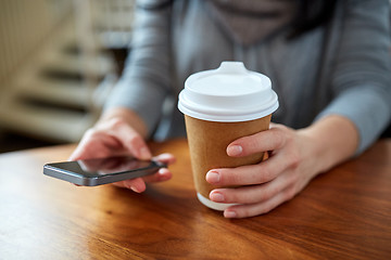 Image showing close up of woman with smartphone and coffee