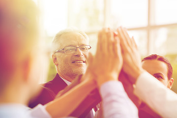 Image showing business people making high five in office