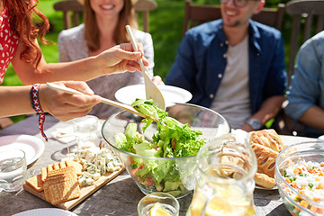 Image showing happy friends having dinner at summer garden party