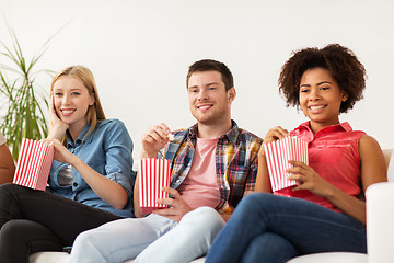 Image showing happy friends with popcorn watching tv at home