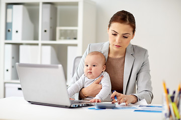 Image showing businesswoman with baby working at office