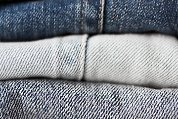 Image showing close up of denim clothes or jeans pile