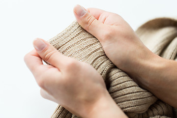 Image showing close up of hands with knitted clothing item