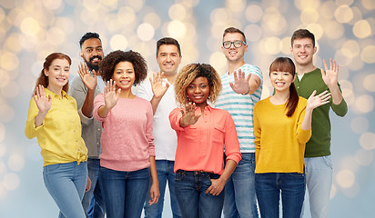 Image showing international group of happy people waving hand