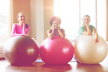 Image showing group of smiling women with exercise balls in gym
