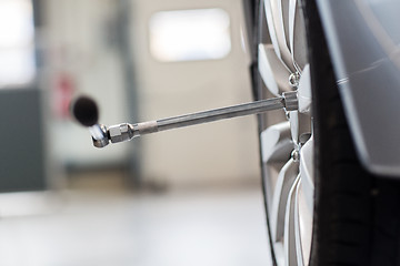 Image showing screwdriver and car wheel tire