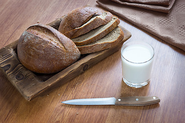 Image showing Bread loaf and milk in glass