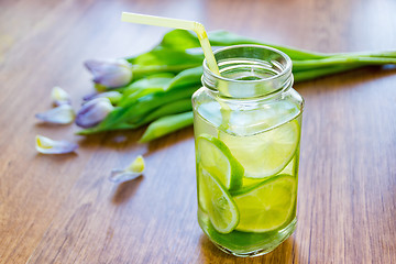 Image showing Lime cocktail in jar and bouquet of tulips