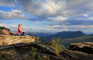 Image showing Woman peaceful yoga on mountain summit