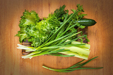 Image showing Fresh vegetables and rustic wooden dish