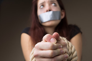 Image showing Woman gagged and tied hands