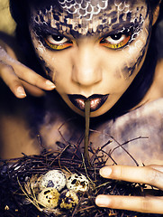 Image showing fashion portrait of pretty young woman with creative make up like a snake, halloween