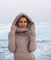 Image showing young pretty woman in sweater at seacoast walking relaxing