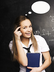 Image showing portrait of happy cute student with book in classroom