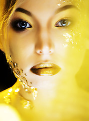 Image showing beauty blond woman with gold creative make up, bokeh on yellow background 