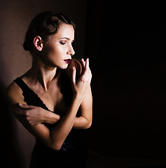 Image showing beauty blond woman in studio on black background, stylish fashion retro vintage