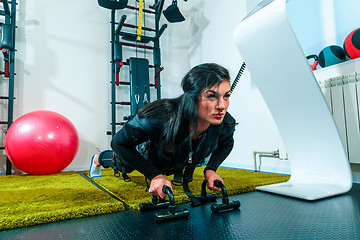 Image showing The female athlete doing they exercise in a ems fitness studio