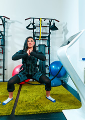 Image showing The female athlete doing they exercise in a ems fitness studio