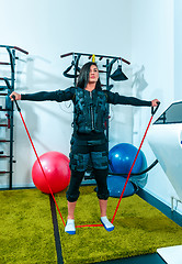 Image showing The female athlete doing they exercise in a ems fitness studio