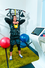 Image showing The female athlete doing they exercise in a ems fitness studio