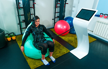 Image showing The female athlete doing they exercise in a ems fitness studio