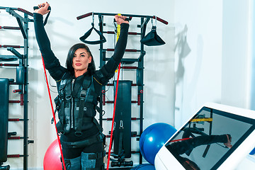 Image showing The female athlete doing they exercise in a ems fitness studio