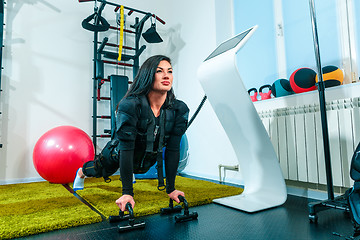 Image showing The female athlete doing they exercise in a ems fitness studio