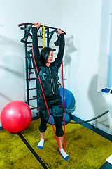 Image showing The female athlete doing they exercise in a ems fitness studio