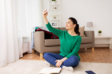 Image showing woman with smartphone taking selfie at home