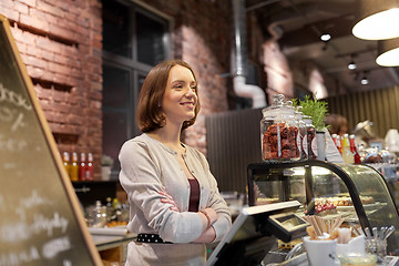 Image showing happy woman or barmaid at cafe counter