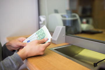 Image showing hands with money at bank or currency exchanger