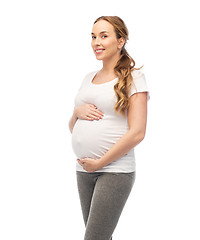 Image showing happy pregnant woman touching her big belly