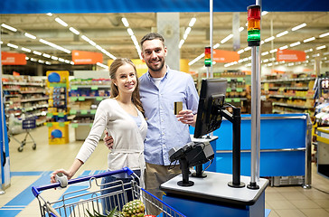 Image showing couple buying food at grocery store cash register