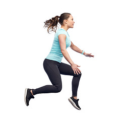 Image showing happy smiling sporty young woman jumping in air