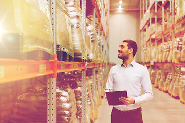 Image showing businessman with clipboard at warehouse