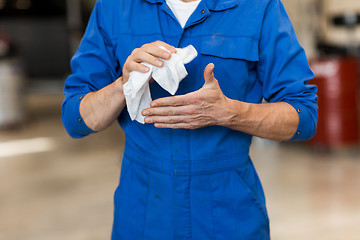 Image showing mechanic man or smith with wipe at car workshop