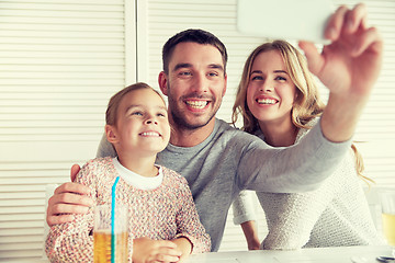 Image showing happy family taking selfie at restaurant