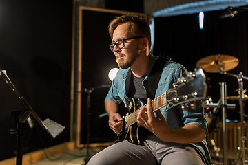 Image showing man playing guitar at studio rehearsal