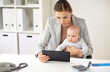 Image showing businesswoman with baby and tablet pc at office