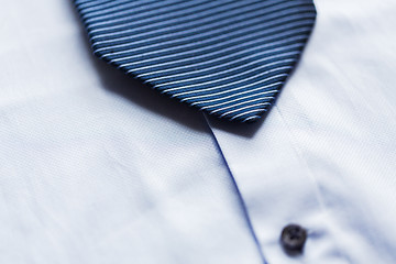 Image showing close up of shirt and blue patterned tie