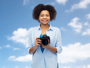 Image showing happy african american woman with digital camera