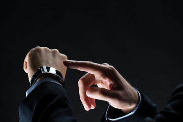 Image showing close up of businessman hands with smart watch