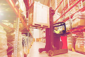 Image showing man on forklift loading cargo at warehouse