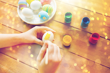 Image showing close up of woman hands coloring easter eggs