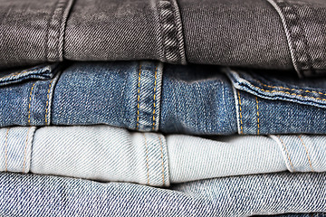 Image showing close up of denim clothes or jeans pile