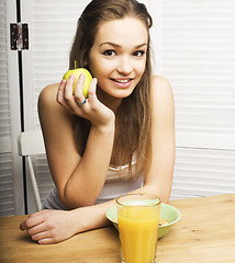 Image showing portrait of happy cute girl with breakfast, green apple and orange juice