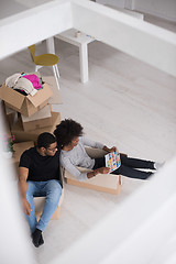 Image showing African American couple  playing with packing material